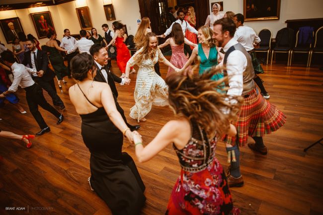 A group dancing at a graduation ball